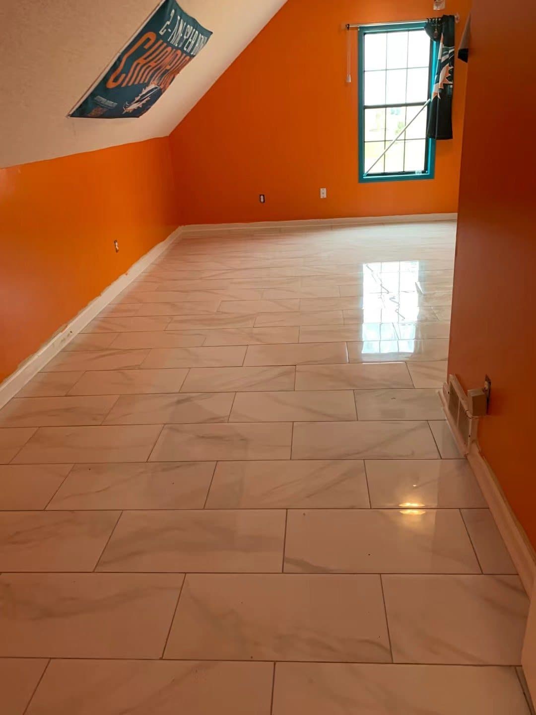 Large-format tile run diagonally through a bedroom
