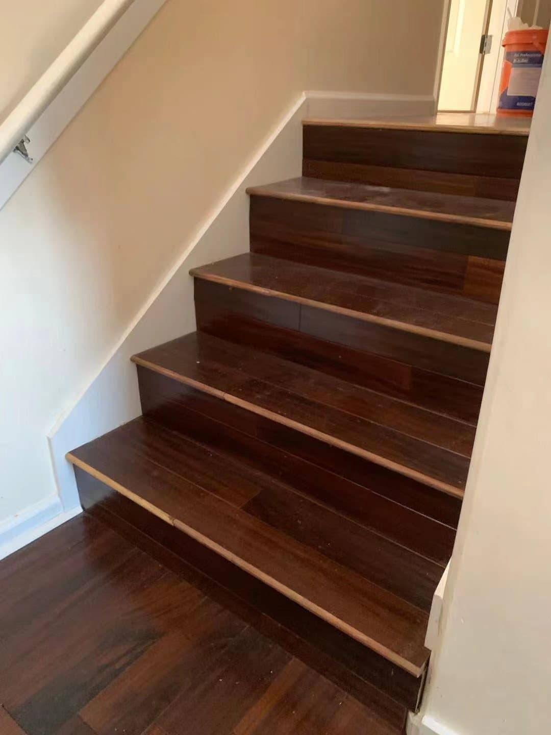 Walnut-stained treads over painted risers